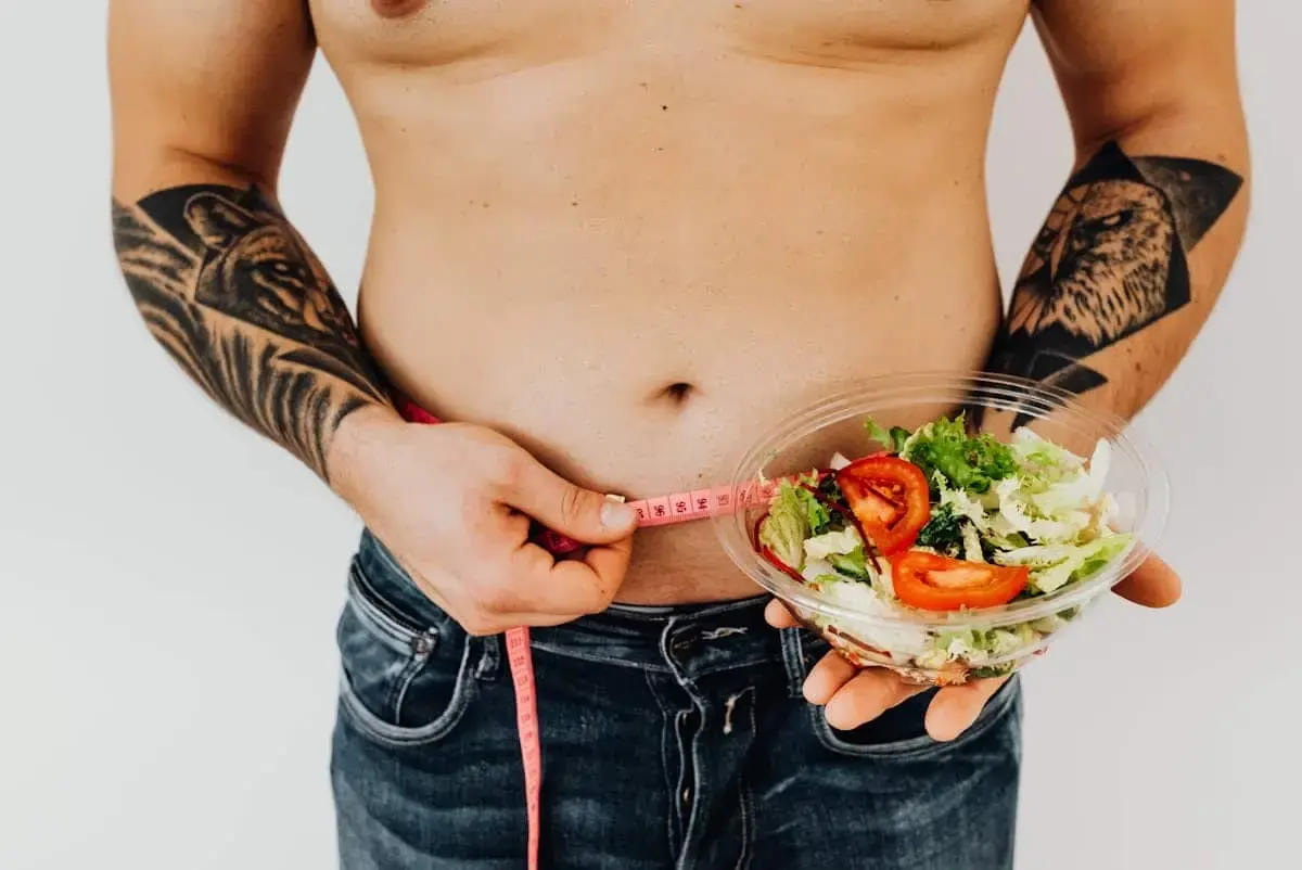 top 10 best diet to lose weight- man carrying salad in bowl with tape