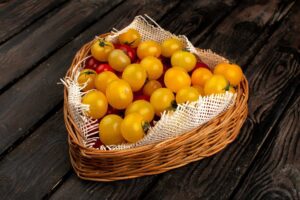 bamboo fruit basket filled with yellow cherry tomatoes